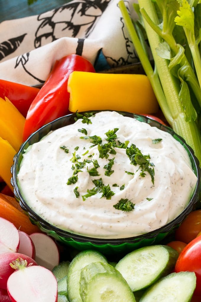 Homemade Ranch Dip Recipe | Homemade Ranch Powder | Homemade Ranch Dressing | Best Ranch Dip #ranch #dip #appetizer #snack #fuyos A bowl of dip topped with chopped parsley and surrounded by vegetables.