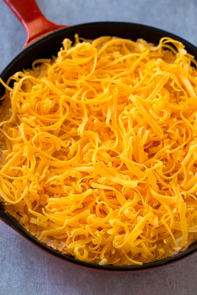 Buffalo Ranch Chicken Dip | Buffalo Chicken Dip | Baked Buffalo Dip | Cheesy Buffalo Dip #buffalowings #buffalochicken #dip #lowcarb #appetizer #fuyos Buffalo chicken dip topped with shredded cheddar cheese, ready to go into the oven.