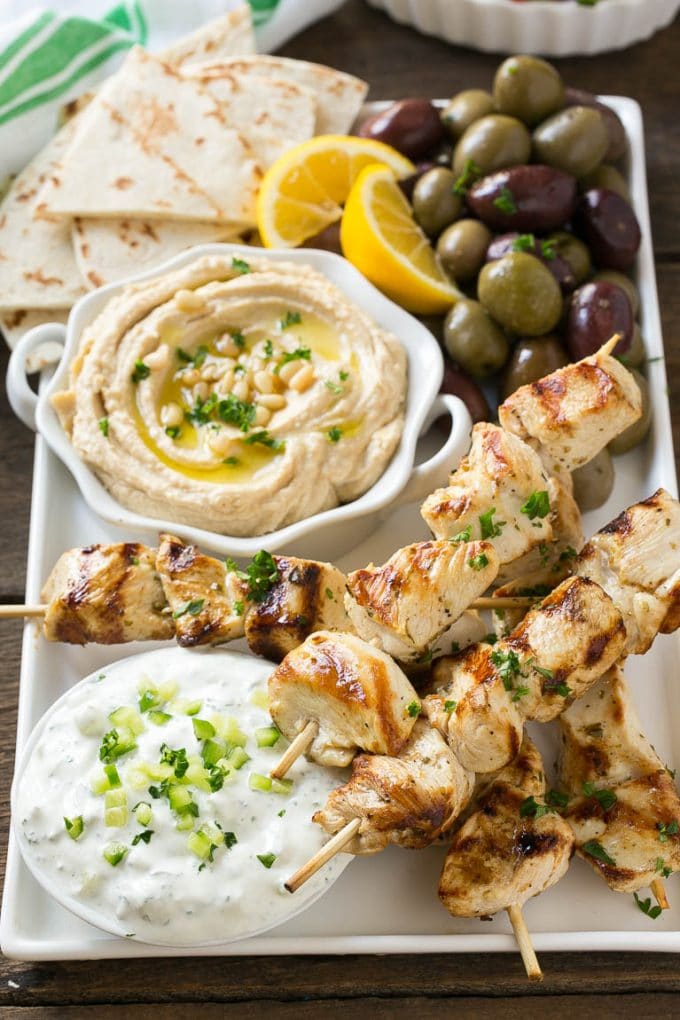 Greek Chicken Souvlaki Recipe | Easy Greek Chicken | Chicken Souvlaki | Greek Chicken Skewers | Easy Greek Chicken Skewers #chicken #kabobs #glutenfree #keto #lowcarb #grilling #fuyos Chicken souvlaki skewers marinated in lemon and herbs, then grilled. Served with olives, hummus and pita bread.