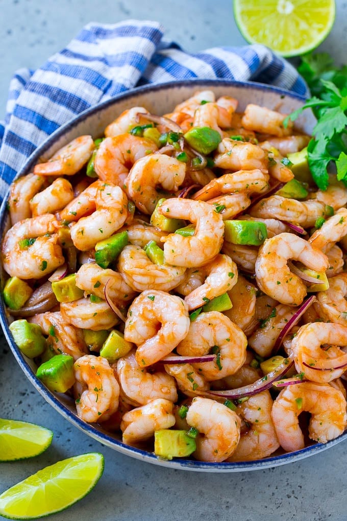 Mexican Shrimp Cocktail Recipe | Coctel de Camarones | Shrimp Cocktail | Mexican Shrimp #shrimp #appetizer #avocado #mexican #fuyos A bowl of Mexican shrimp cocktail with red onion, avocado, homemade sauce and cilantro.