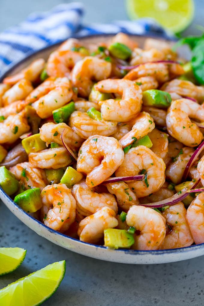 Mexican Shrimp Cocktail Recipe | Coctel de Camarones | Shrimp Cocktail | Mexican Shrimp #shrimp #appetizer #avocado #mexican #fuyos A serving bowl of Mexican shrimp cocktail which contains small shrimp, diced avocado, herbs and jalapeno.