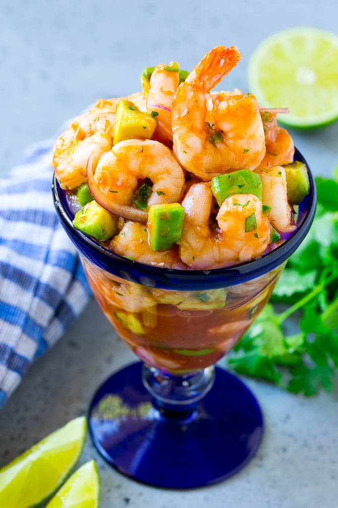 Mexican Shrimp Cocktail Recipe | Coctel de Camarones | Shrimp Cocktail | Mexican Shrimp #shrimp #appetizer #avocado #mexican #fuyos An individual cup of Mexican shrimp cocktail with red onion and avocado.