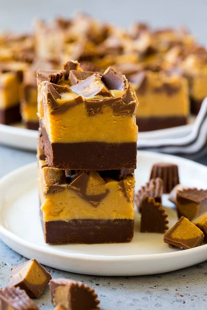 Chocolate Peanut Butter Fudge Recipe | Peanut Butter Cup Fudge | Easy Fudge Recipe #chocolate #peanutbutter #fudge #baking #dessert #fuyos Stacked pieces of chocolate peanut butter fudge on a plate.
