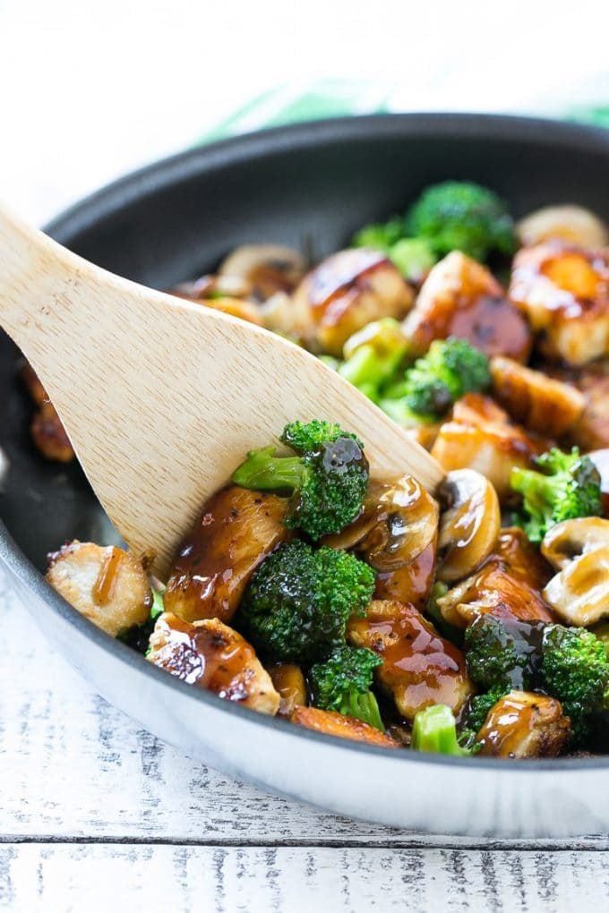 Chicken and Broccoli Stir Fry Recipe | Chicken Stir Fry | Healthy Chicken Recipe | Chicken and Broccoli | Chinese Food #chicken #broccoli #stirfry #healthy #cleaneating #dinner #fuyos A spatula scooping chicken stir fry out of a pan.