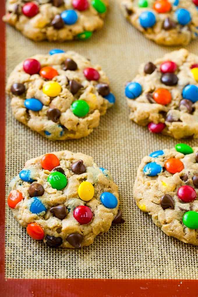 Monster Cookies Recipe | Oatmeal Cookies | Peanut Butter Cookies | M&M's Cookies #baking #cookies #dessert #peanutbutter #chocolate #fuyos Baked monster cookies on a sheet pan.