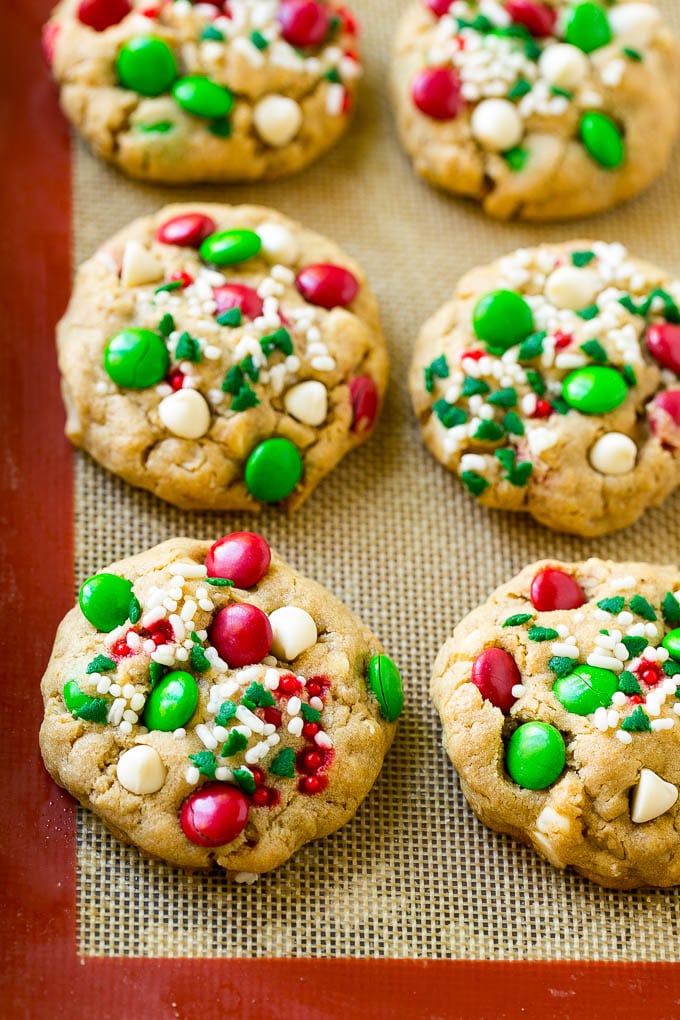 Christmas Monster Cookies Recipe | Oatmeal Cookies | Peanut Butter Cookies | M&M's Cookies #baking #cookies #dessert #peanutbutter #chocolate #fuyos #christmas #sprinkles Baked Christmas cookies on a sheet pan.