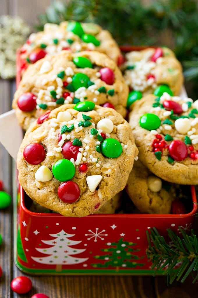 Christmas Monster Cookies Recipe | Oatmeal Cookies | Peanut Butter Cookies | M&M's Cookies #baking #cookies #dessert #peanutbutter #chocolate #fuyos #christmas #sprinkles Christmas monster cookies in a gift tin.