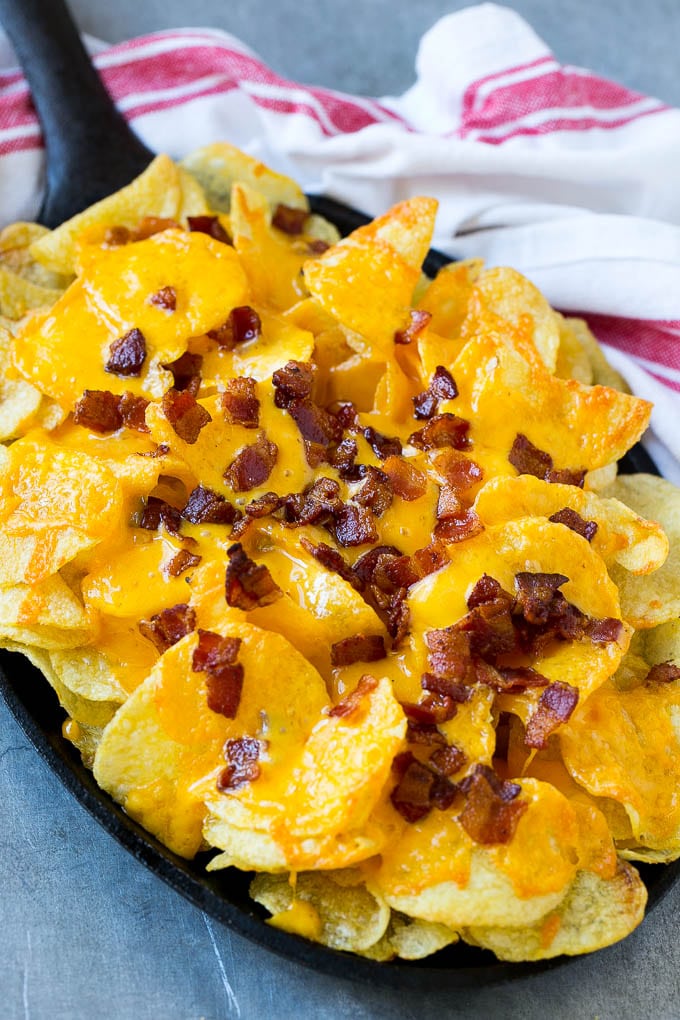 Potato chips topped with melted cheese and bacon.