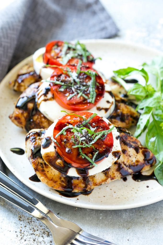 Grilled chicken breasts topped with mozzarella cheese, tomatoes and basil.