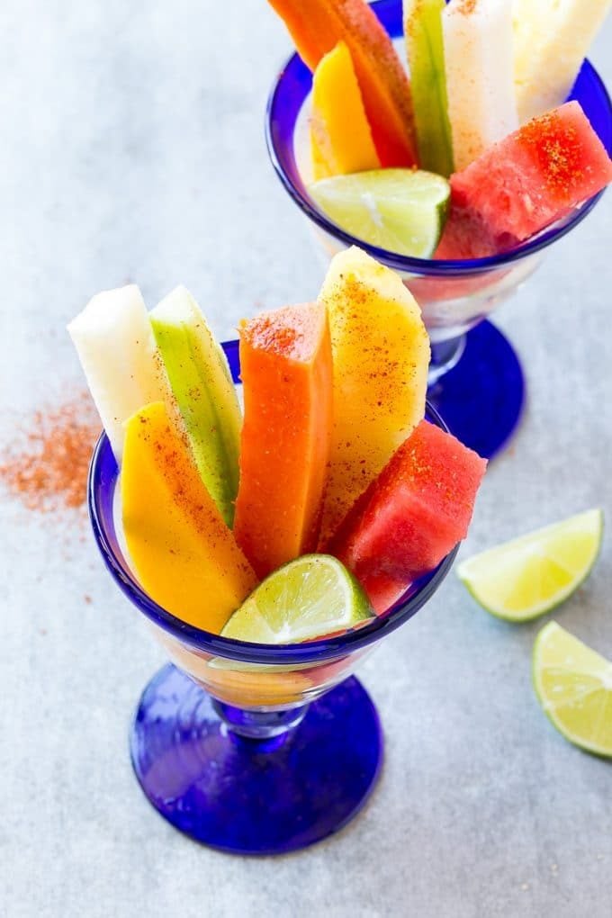 Mexican Fruit Cups | Fruit Cups | Mexican Fruit | Tropical Fruit #fruit #fruitcup #watermelon #pineapple #snack #healthy #fuyos Mexican fruit cups with an assortment of fruit, topped with chili lime seasoning.