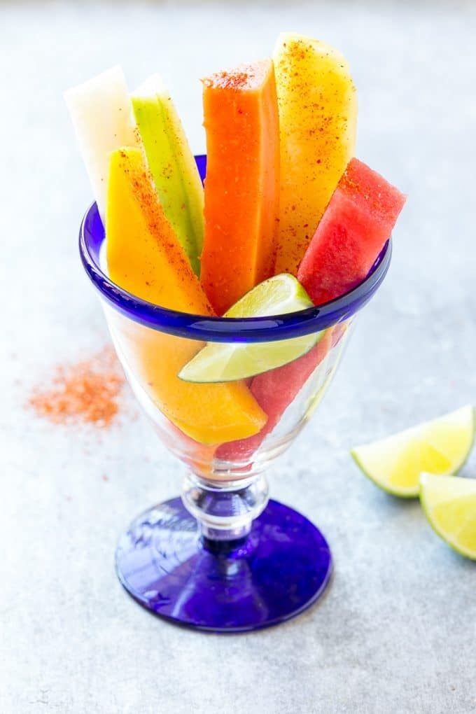 Mexican Fruit Cups | Fruit Cups | Mexican Fruit | Tropical Fruit #fruit #fruitcup #watermelon #pineapple #snack #healthy #fuyos Mexican fruit cups topped with chili lime seasoning.