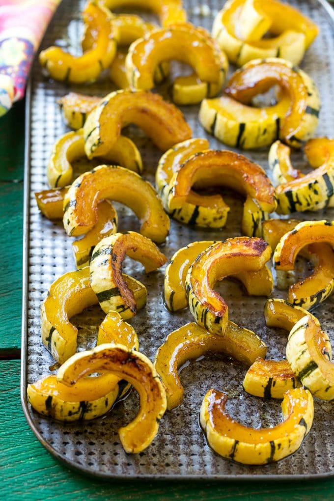 Brown Sugar Delicata Squash Recipe | Roasted Squash | Delicata Squash | Winter Squash Recipe #squash #wintersquash #brownsugar #sidedish #delicatasquash #dinner #fuyos A sheet pan of a cooked winter squash recipe.