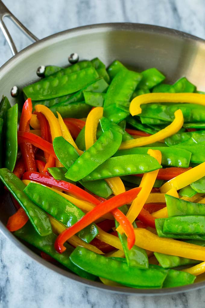 Teriyaki Shrimp Stir Fry Recipe | Shrimp Stir Fry | Healthy Stir Fry #shrimp #teriyaki #vegetables #stirfry #dinner #fuyos Cooked snow peas and bell peppers in a skillet.