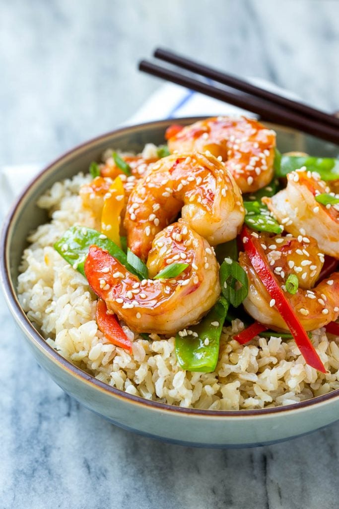 Teriyaki Shrimp Stir Fry Recipe | Shrimp Stir Fry | Healthy Stir Fry #shrimp #teriyaki #vegetables #stirfry #dinner #fuyos A bowl of shrimp stir fry and vegetables garnished with sesame seeds.