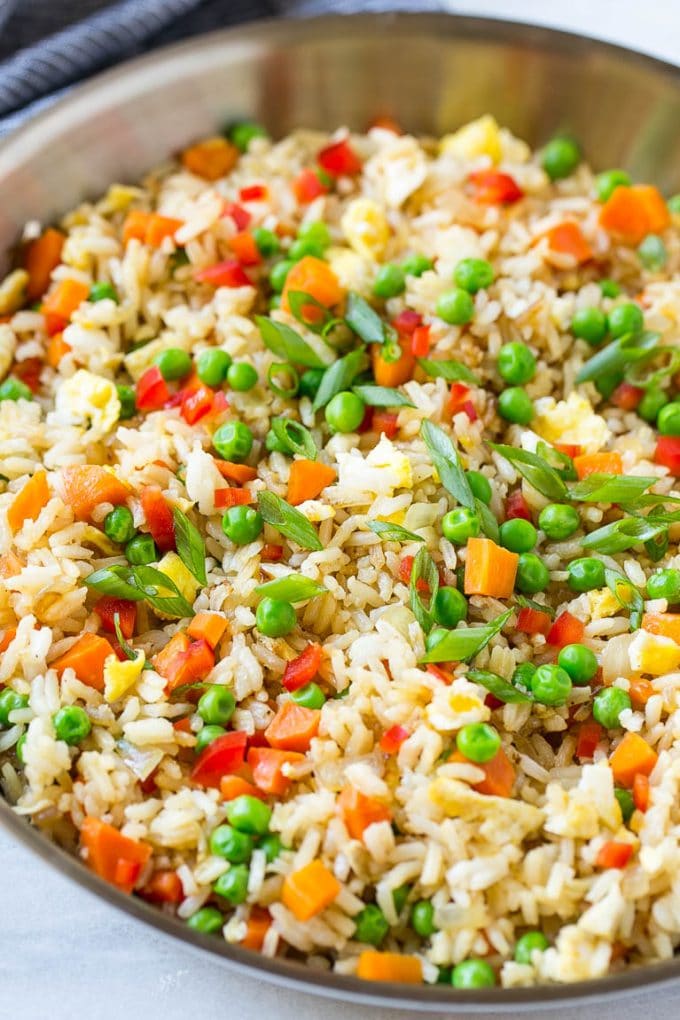 Veggie Fried Rice Recipe | Vegetarian Fried Rice | Easy Fried Rice Recipe | Chinese Food #rice #friedrice #veggie #vegetarian #sidedish #fuyos A skillet of vegetarian fried rice with eggs, peas, carrots and peppers.