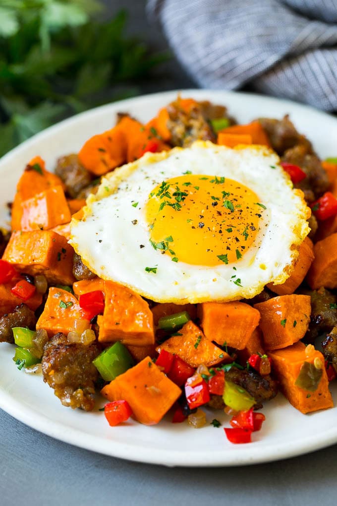 Sweet Potato Hash #sweetpotato #sausage #breakfast #brunch #fuyos Sweet potato hash with sausage, topped with a fried egg.