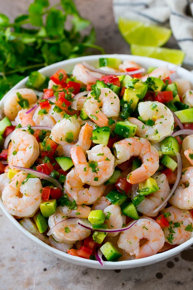 Shrimp Ceviche Recipe | Mexican Shrimp | Marinated Shrimp #shrimp #ceviche #cleaneating #healthy #lowcarb #keto #glutenfree #dinner #appetizer #fuyos A bowl of shrimp ceviche marinated in citrus juice with tomato, avocado, cilantro and jalapeno.