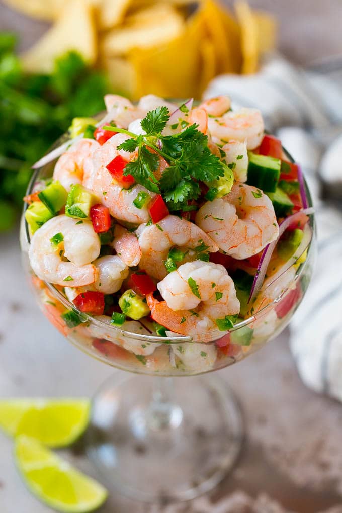 Shrimp Ceviche Recipe | Mexican Shrimp | Marinated Shrimp #shrimp #ceviche #cleaneating #healthy #lowcarb #keto #glutenfree #dinner #appetizer #fuyos Shrimp ceviche in a serving cup garnished with cilantro.