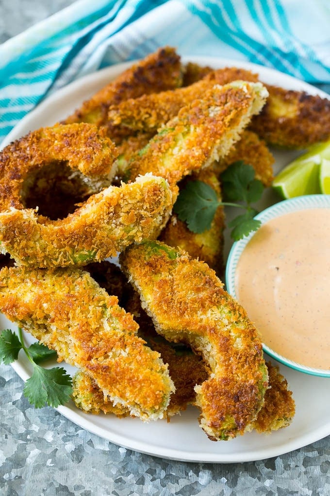 Avocado Fries Recipe | Fried Avocado | Avocado Fritters #avocado #appetizer #snack #fuyos A plate of avocado fries served with dipping sauce.