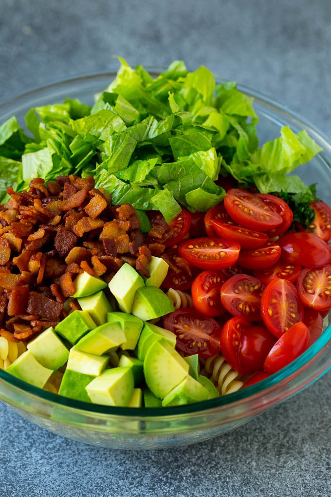 BLT Pasta Salad Recipe | Easy Pasta Salad | Bacon Pasta Salad #salad #pasta #blt #bacon #avocado #dinner #fuyos Bacon, lettuce, tomato, pasta and avocado in a bowl.