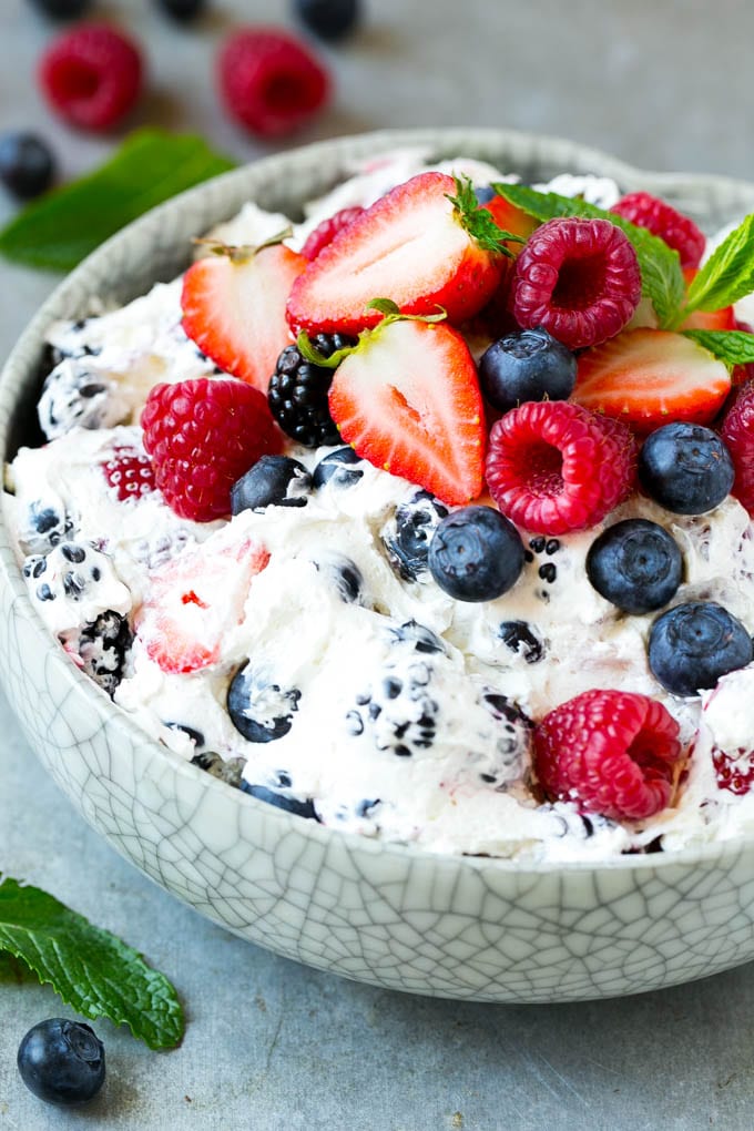 Berry Cheesecake Salad Recipe | Fruit Salad | Berry Fruit Salad | Cheesecake Salad #salad #cheesecake #fruit #berries #sidedish #dessert #fuyos A serving bowl of creamy berry salad topped with blueberries, raspberries and strawberries.