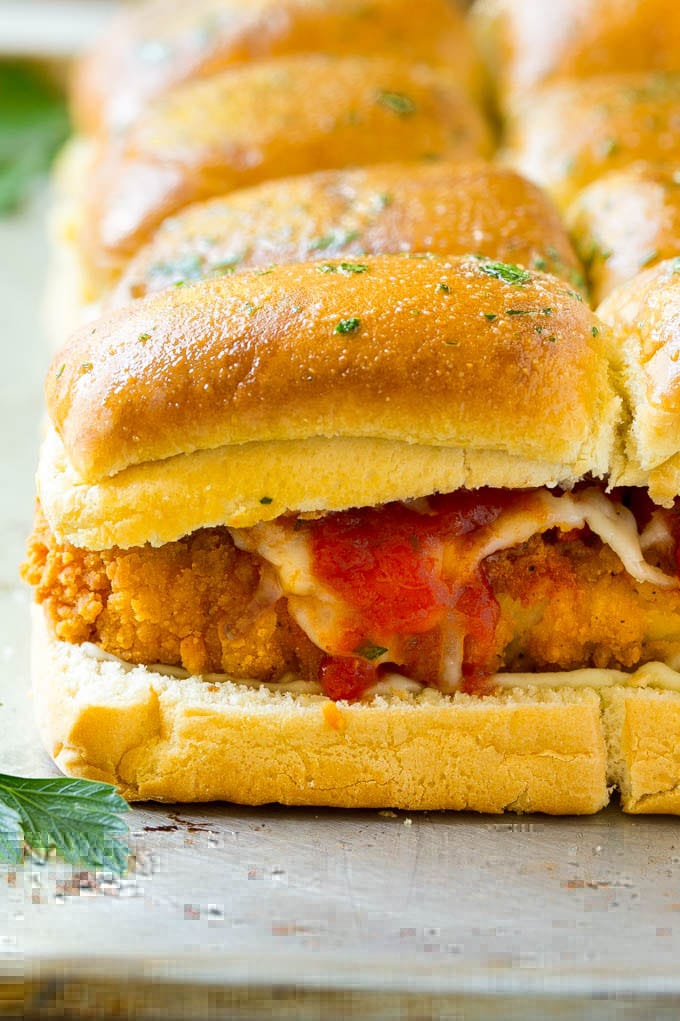 Chicken Parmesan Sliders | Chicken Parmesan Sandwich Recipe | Slider Sandwich Recipe #sliders #chickenparm #chickenparmesan #chickenparmesansliders #dinner #appetizer #fuyos Crispy chicken with tomato sauce and cheese on slider buns.