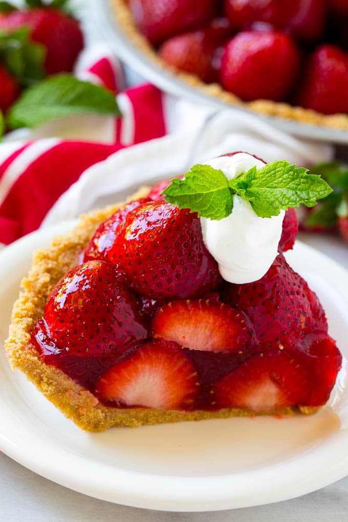 No Bake Strawberry Pie Recipe | Fresh Strawberry Pie | Strawberry Pie Recipe | No Bake Pie Recipe #strawberry #strawberrypie #nobake #nobakepie #dessert #fuyos A slice of no bake fresh strawberry pie with whipped cream on top.
