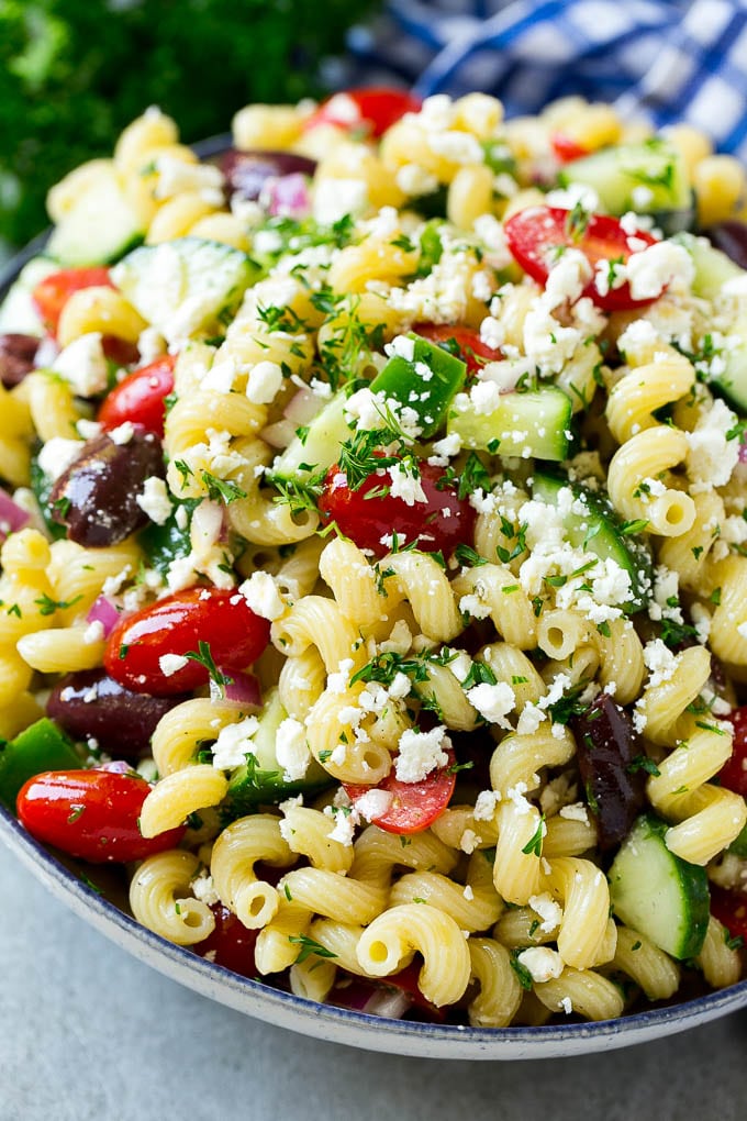 Greek Pasta Salad | Easy Pasta Salad | Vegetable Pasta Salad #pasta #salad #greek #cucumber #tomato #vegetarian #dinner #fuyos A bowl of Greek pasta salad loaded with feta cheese, olives, tomatoes, cucumber and bell peppers.