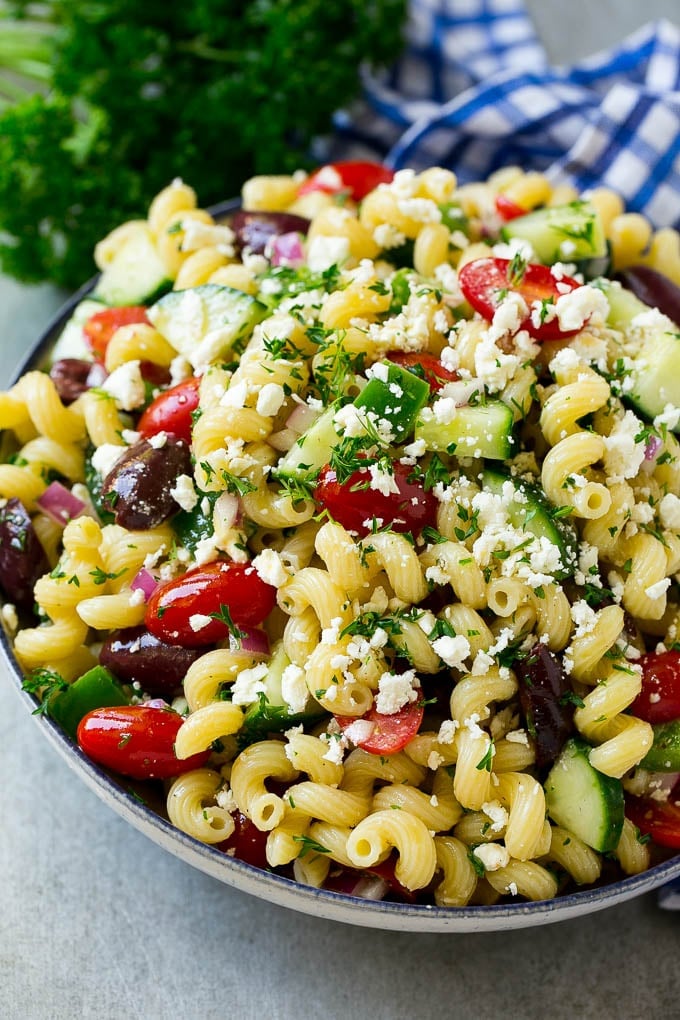 Greek Pasta Salad | Easy Pasta Salad | Vegetable Pasta Salad #pasta #salad #greek #cucumber #tomato #vegetarian #dinner #fuyos Greek pasta salad in a serving bowl, garnished with parsley.