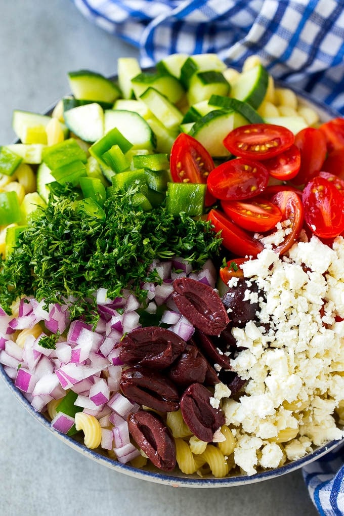 Greek Pasta Salad | Easy Pasta Salad | Vegetable Pasta Salad #pasta #salad #greek #cucumber #tomato #vegetarian #dinner #fuyos Cherry tomatoes, bell pepper, olives, feta, herbs and cucumbers over pasta.