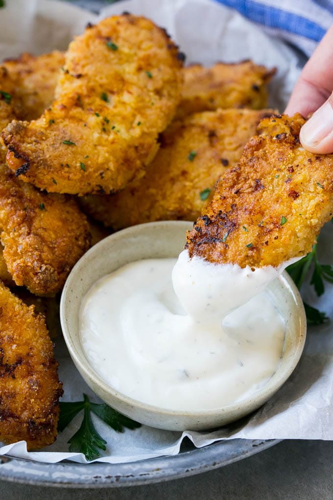 Baked Fried Chicken Recipe | Oven Fried Chicken | Baked Chicken Fingers | Crispy Chicken Fingers #chicken #friedchicken #bakedchicken #ovenfriedchicken #chickenfingers #dinner #fuyos A chicken finger being dipped into ranch dressing.