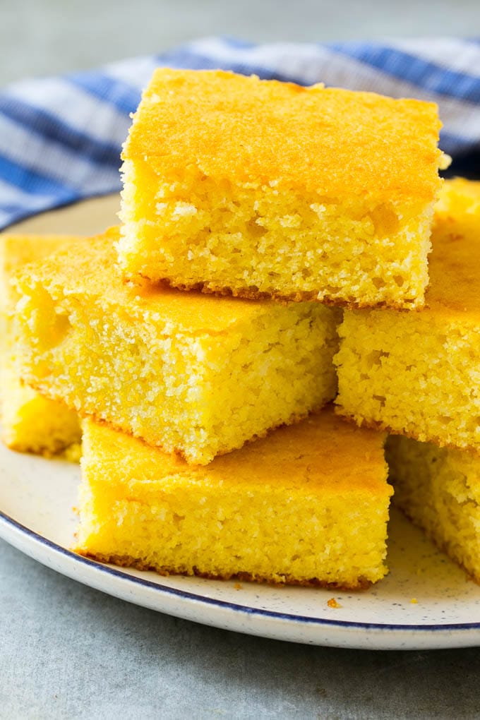 Honey Cornbread Recipe | Buttermilk Cornbread | Easy Cornbread | Homemade Cornbread | Cast Iron Cornbread #cornbread #honey #buttermilk #bread #fuyos A plate full of squares of bread made with cornmeal.