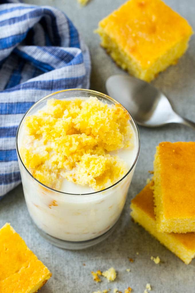 Honey Cornbread Recipe | Buttermilk Cornbread | Easy Cornbread | Homemade Cornbread | Cast Iron Cornbread #cornbread #honey #buttermilk #bread #fuyos A glass of milk with cornbread crumbled into it.
