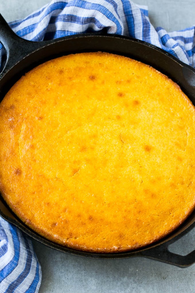 Honey Cornbread Recipe | Buttermilk Cornbread | Easy Cornbread | Homemade Cornbread | Cast Iron Cornbread #cornbread #honey #buttermilk #bread #fuyos A cast iron pan of honey cornbread.