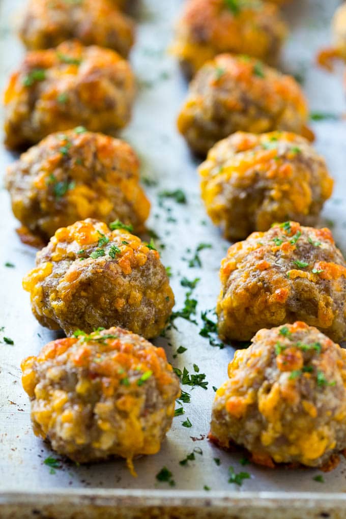 Sausage Cheese Balls Recipe | Sausage Balls Recipe | Bisquick Sausage Balls #sausage #sausageballs #balls #appetizer #cheeseballs #fuyos Cooked meatballs on a baking sheet.