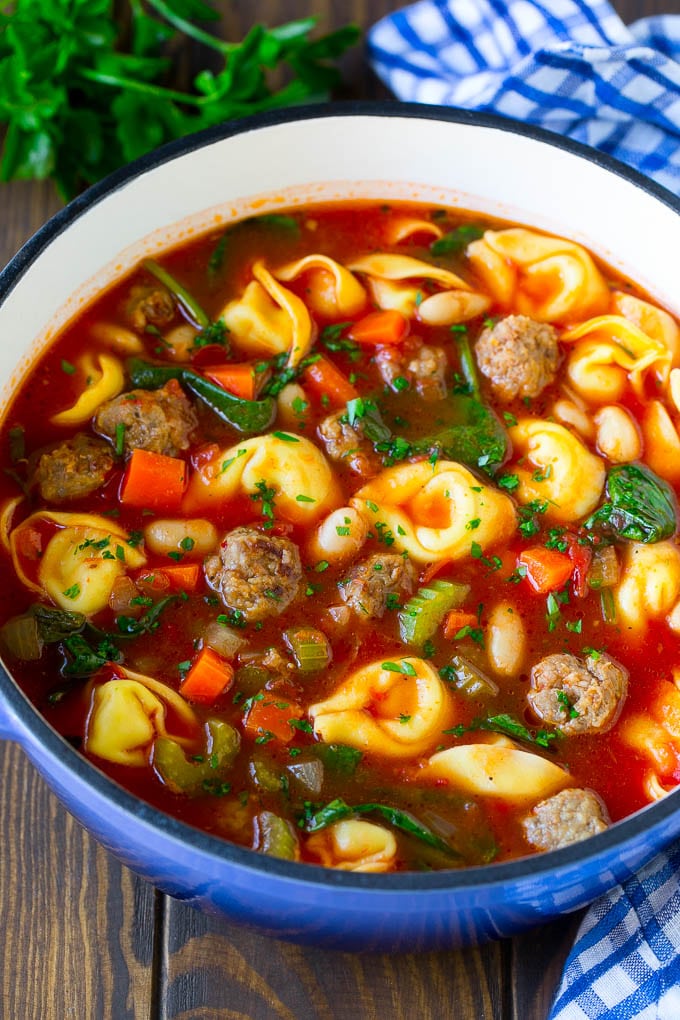 Tortellini Soup Recipe | Sausage Soup | Italian Soup #soup #sausage #pasta #tortellini #dinner #fuyos A pot of tortellini soup with tomato broth, Italian sausage, spinach and carrots.