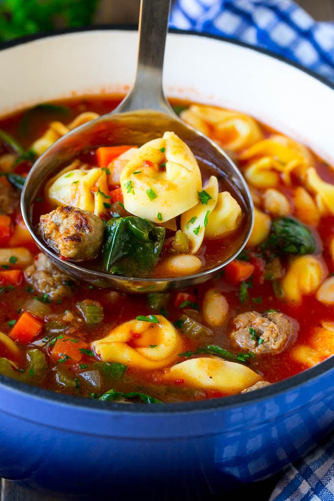 Tortellini Soup Recipe | Sausage Soup | Italian Soup #soup #sausage #pasta #tortellini #dinner #fuyos A ladle serving up a portion of tortellini soup.
