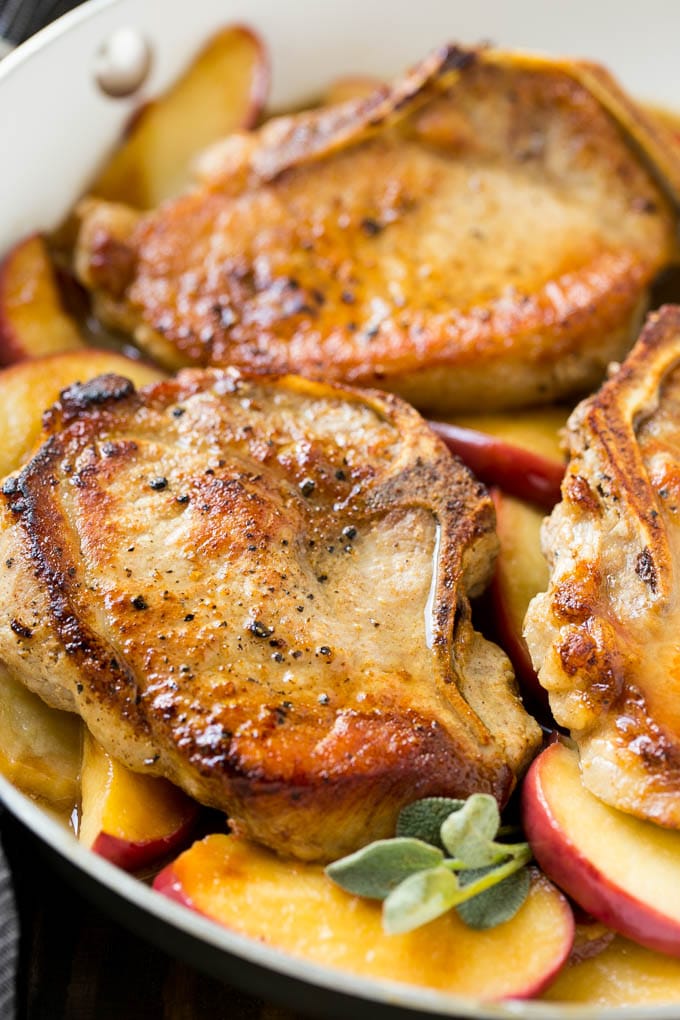 Apple Pork Chops Recipe | Pork Chops with Apples | Cider Pork Chops | Bone In Pork Chops Recipe #pork #porkchops #fall #apple #dinner #fuyos Seared pork in a pan in a sweet and savory sauce with fresh herbs.
