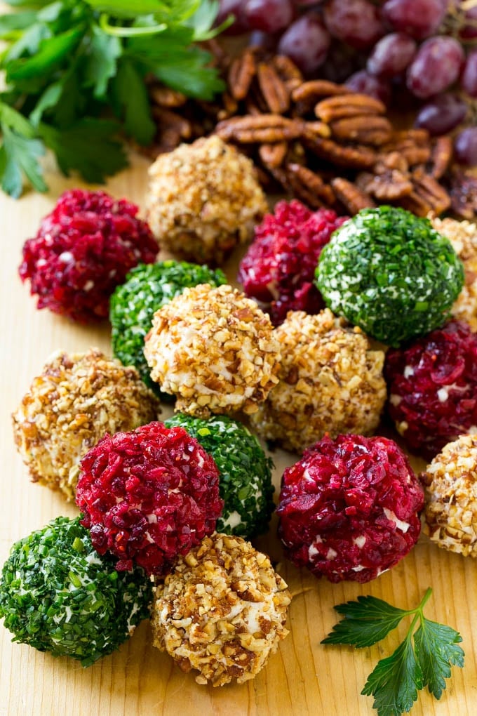 Cheese Ball Bites Recipe | Holiday Cheese Ball Recipe | Pecan Cheese Ball | Cranberry Cheese Ball | Mini Cheese Balls #cheeseball #cheese #appetizer #fuyos Cheese ball bites rolled in assorted toppings and served with fruit and nuts.