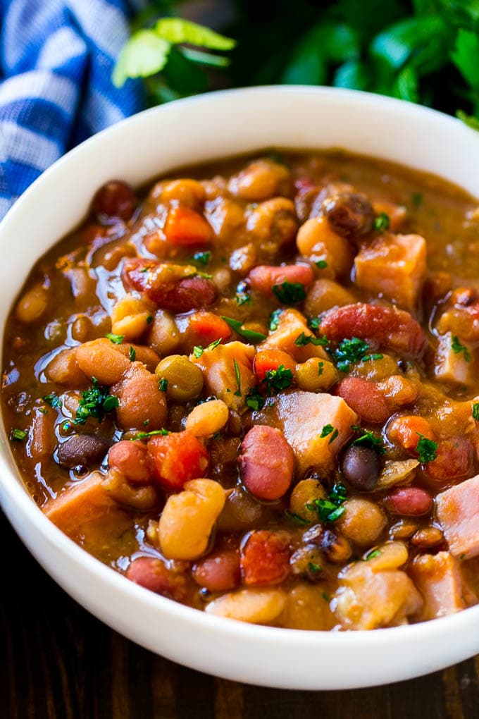 Slow Cooker Ham Bone Soup | Ham and Bean Soup | Ham Bone and Bean Soup | Ham Soup | Leftover Ham Recipe #ham #hamsoup #leftoverham #soup #slowcooker #crockpot #fuyos A bowl of ham bone soup with beans and vegetables.
