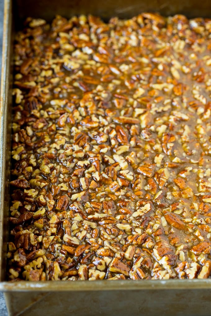 Pecan Pie Bars Recipe #pecans #pie #fall #pecanpie #dessert #thanksgiving #fuyos Pecans and brown sugar poured over a cookie crust.