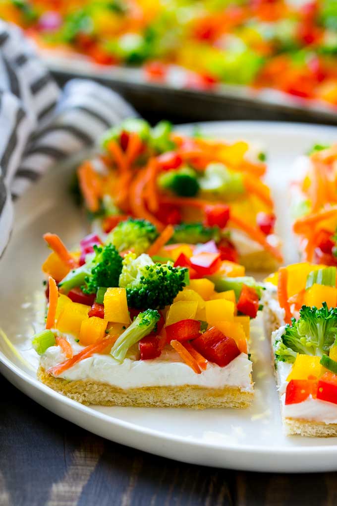 Veggie Pizza Recipe | Crescent Veggie Pizza | Vegetable Pizza Recipe | Holiday Appetizer | Homemade Veggie Pizza #pizza #veggies #vegetarian #appetizer #fuyos Slices of veggie pizza on a serving plate.
