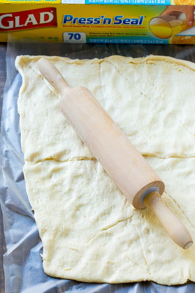 Veggie Pizza Recipe | Crescent Veggie Pizza | Vegetable Pizza Recipe | Holiday Appetizer | Homemade Veggie Pizza #pizza #veggies #vegetarian #appetizer #fuyos Crescent roll dough rolled out into a rectangle.