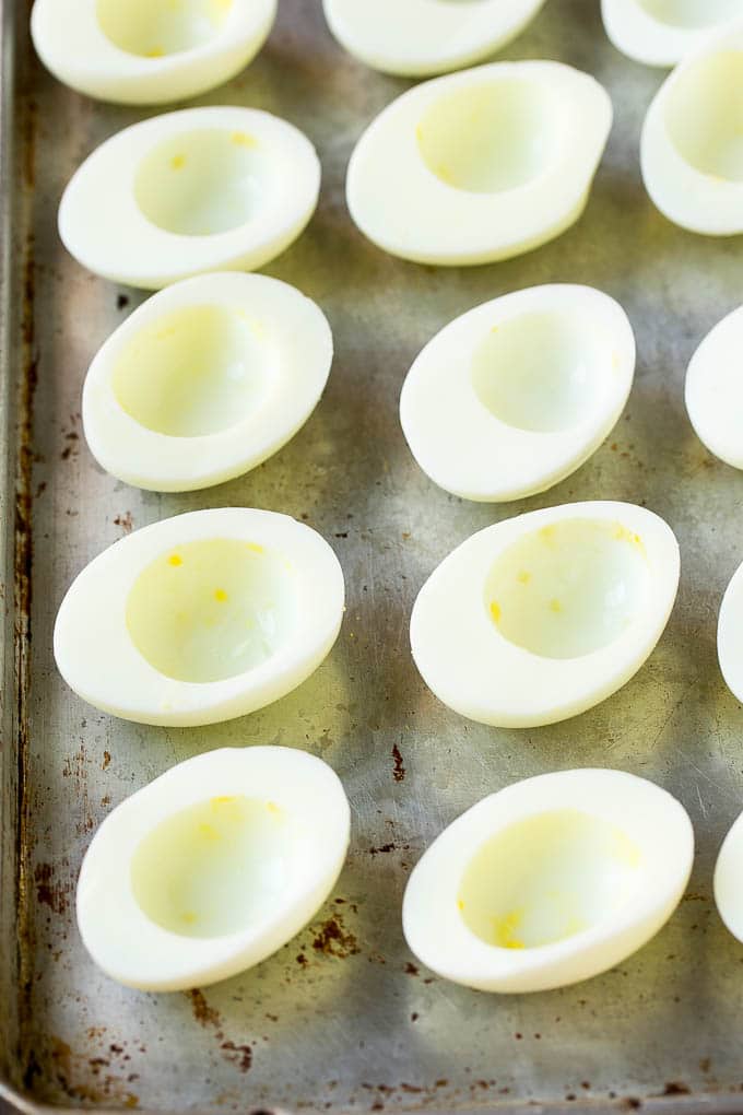 Bacon Deviled Eggs | Deviled Eggs Recipe #eggs #keto #lowcarb #bacon #appetizer #fuyos Egg white halves on a sheet pan.
