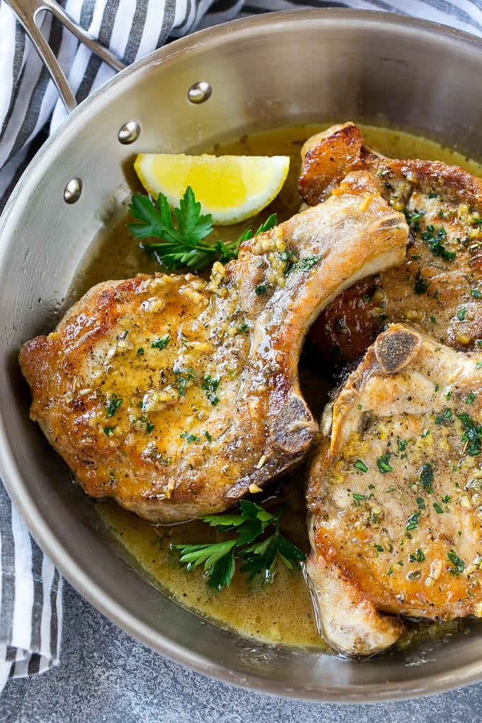 Brown Sugar Pork Chops Recipe | Bone In Pork Chops Recipe | Garlic Butter Pork Chops | Skillet Pork Chops #pork #porkchops #garlic #dinner #glutenfree #fuyos Brown sugar pork chops with garlic, butter and herbs in a frying pan.