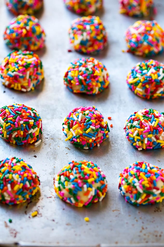 Funfetti Cookies Recipe | Funfetti Cake Mix Cookies | Sprinkle Cookies | Cake Mix Cookies #cookies #funfetti #sprinkles #dessert #fuyos Balls of cookie dough coated in sprinkles.