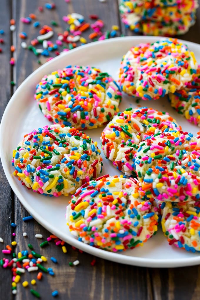 Funfetti Cookies Recipe | Funfetti Cake Mix Cookies | Sprinkle Cookies | Cake Mix Cookies #cookies #funfetti #sprinkles #dessert #fuyos A plate of funfetti cookies coverd in rainbow sprinkles.
