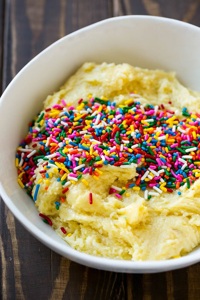 Funfetti Cookies Recipe | Funfetti Cake Mix Cookies | Sprinkle Cookies | Cake Mix Cookies #cookies #funfetti #sprinkles #dessert #fuyos Cookie dough in a bowl with sprinkles on top.