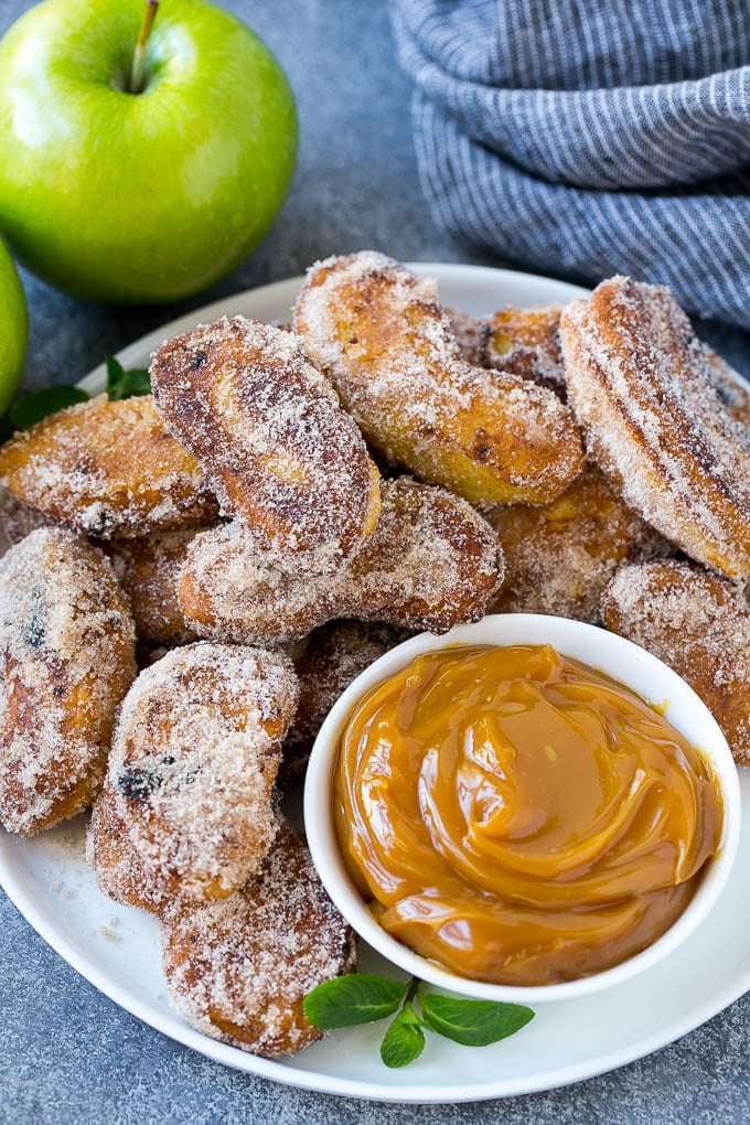 Apple Fries Recipe | Fried Apples Recipe | Cinnamon Sugar Apples | Apple Dessert Recipe #apples #dessert #fuyos #fall A pile of cinnamon sugar apple fries with caramel sauce for dipping.