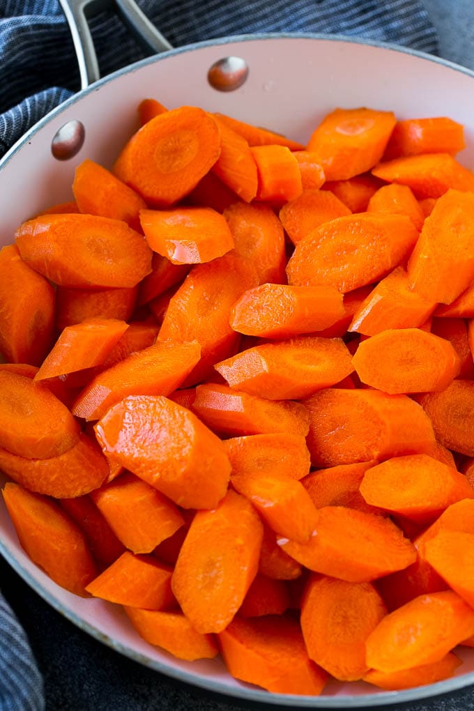 Candied Carrots Recipe | Carrot Side Dish | Brown Sugar Carrots | Glazed Carrots #carrots #brownsugar #sidedish #dinner #fuyos Raw sliced carrots in a pan.